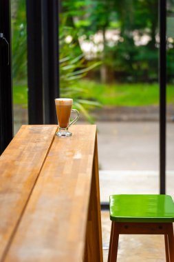 doğal arka plan ile pencere yakınında kafe masada kapuçino ile cam