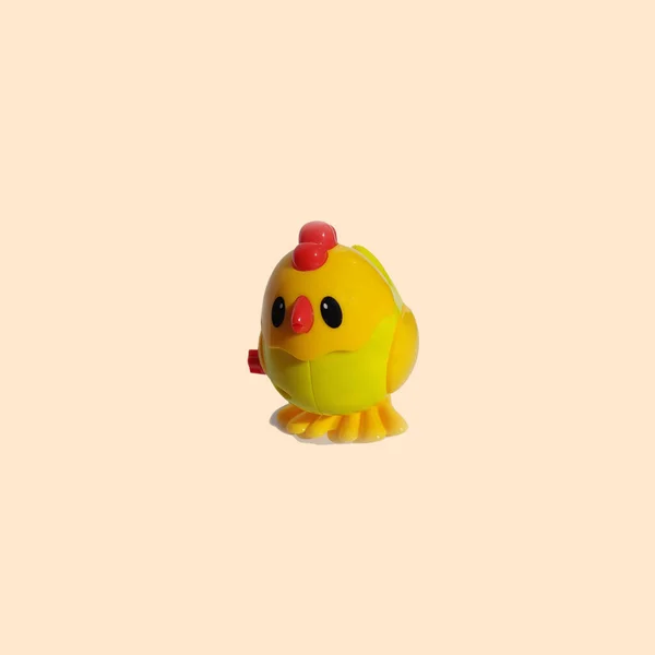toy yellow chicken on a light background. animal bird figurine farm.