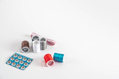 Sewing thread bobbins on the white background. Closeup.