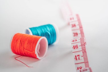 Sewing thread bobbins on the white background. Closeup.
