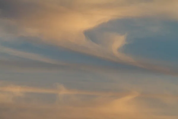 Colorful cloud patterns with golden hour light.