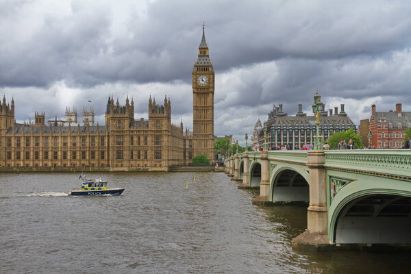 London, England; May 24, 2014. The English police patrol the river Thames with the Parliament and Big Ben in the background.
