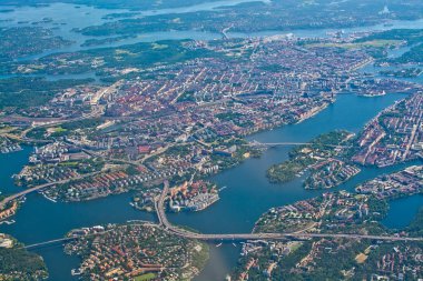 STOCKHOLM, SWEDEN - JUNE 1, 2018: Aerial shot over Stockholm, Sodermalm, Old Town island Essingeleden and Djurgarden, during inflight to Arlanda airport on a sunny day on June 1, 20108 in Stockholm, Sweden. clipart