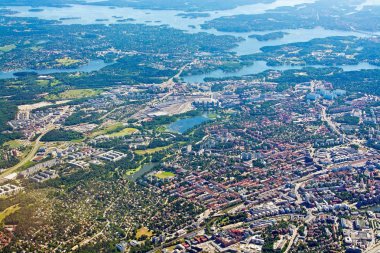 STOCKHOLM, SWEDEN - JUNE 1, 2018: Aerial shot over Solna Sundbyberg Stockholm during inflight to Arlanda airport on a sunny day on June 1, 20108 in Stockholm, Sweden. clipart