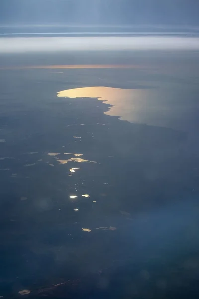 Aerial landscape with golden light over bay of water — Stock Photo, Image