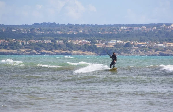 Surfers play in the green waves — Stock Photo, Image