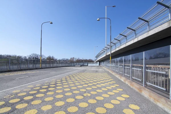 Yellow dots on wide pedestrian bridge — 스톡 사진