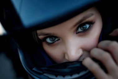 Beautiful eyes of a girl in a motorcycle helmet. clipart
