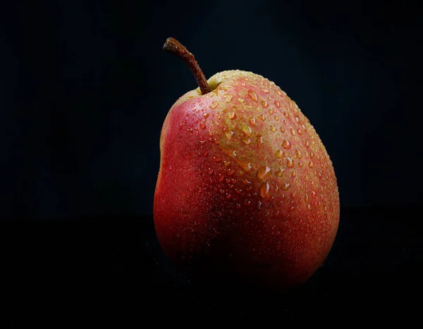黒の背景にとても美しい熟した梨 — ストック写真