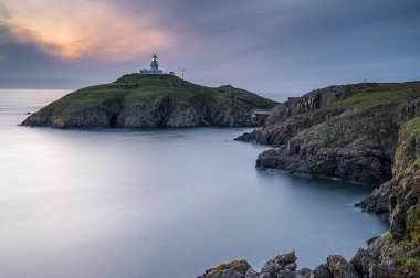 Strumble Baş Feneri, Pembrokeshire, gün batımında.