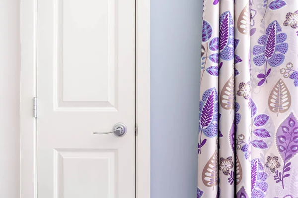 Home interior showing colonial closet door with purple curtain decor and light blue painted wall. — Stock Photo, Image