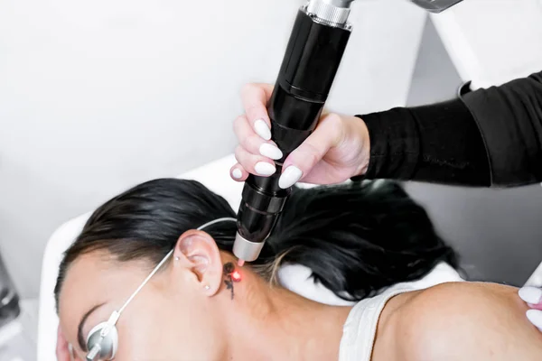 Laser tattoo removal treatment session on patient, using picosecond technology, to break down tattoo ink into smaller particles. At a beauty and skincare clinic for aesthetic lasers. — Stock Photo, Image