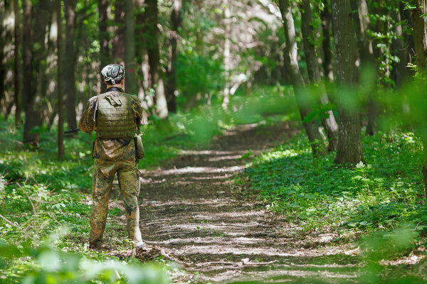 Airsoft soldier player waiting on the road on block post