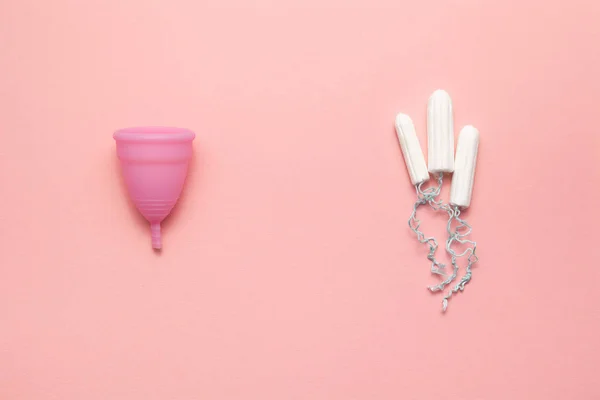 Herbruikbare siliconen menstruele beker en tampons vergelijking op een zachte roze achtergrond. Moderne vrouwelijke intieme alternatieve gynaecologische hygiëne. Eco Zero Waste concept — Stockfoto