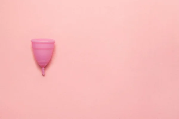 Tazza mestruale in silicone riutilizzabile su uno sfondo rosa morbido. Moderna femminile intima igiene ginecologica alternativa. Concetto di rifiuti eco zero. Copia spazio per il testo. Posa piatta — Foto Stock