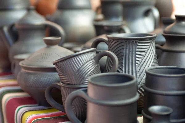 Ternopil, Ukraine, 24-07-2019. Selective focus. Dark black ceramic clay pottery. Traditional pottery fair. Ukrainian Carpathian pots — Stock Photo, Image