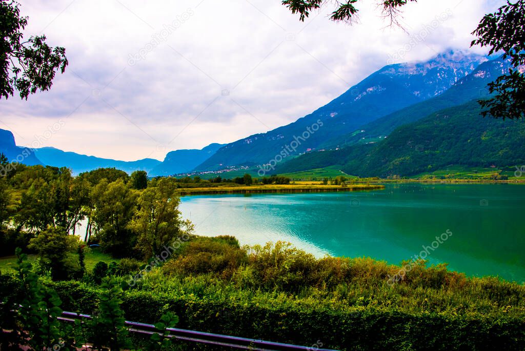 photo of Lake Caldaro enclosed in the mountains in Bolzano Italy