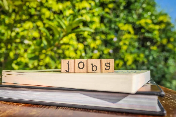 Word Jobs Letters Block Cubes Top Books Wooden Table Green — Stock Photo, Image