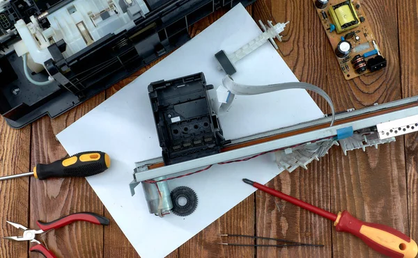 Printer disassembled into parts. Repair of the printer. Print head of the printer close-up.