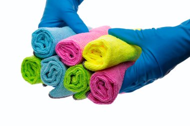hands in blue gloves hold a set of cleaning rags clipart