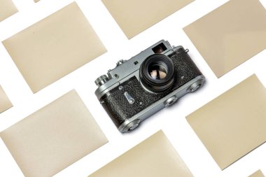 Beyaz zemin üzerinde eski Rangefinder film kamerası ve fotoğraf kağıdının maketi.