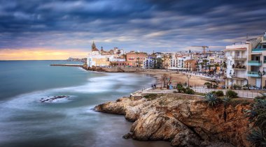 Sitges is known for its beaches, nightspots, and historical sites. clipart