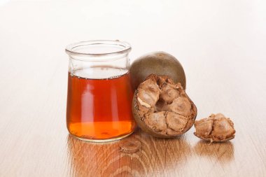 Luo Han Guo aka Monk fruit natural remedy on wooden background. Powerful healthy sweetener. clipart
