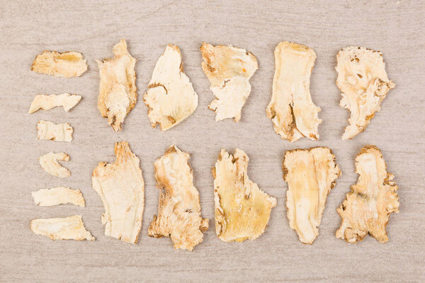 Dong quai, traditional chinese medicine. Angelica roots on white background. Medical herb.