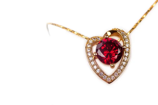 Guld hänge med ädla stenar i form av ett hjärta Royaltyfria Stockfoton