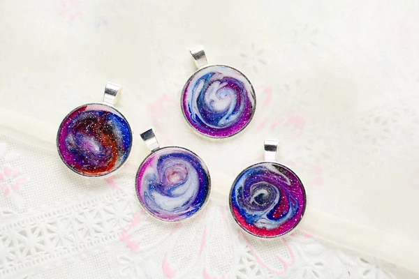 Create galaxy drink coasters using resin, glitter and pigment po