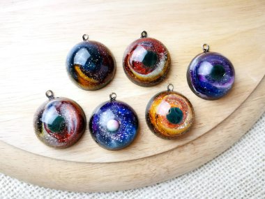 Create galaxy drink coasters using resin, glitter and pigment po clipart