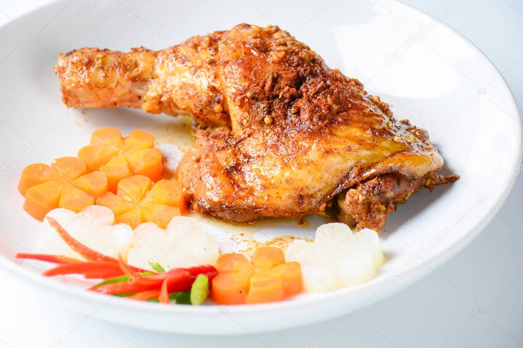 Hot and spicy baked chicken on white plate