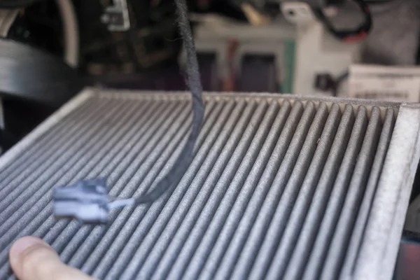 The process of cleaning car air conditioning. Dirty air conditioner filter of car.