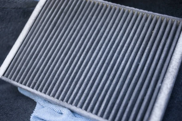 The process of cleaning car air conditioning. Dirty air conditioner filter of car.