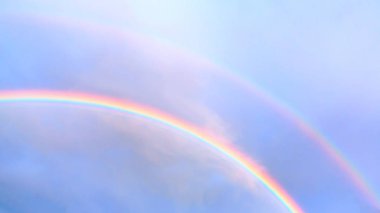 Bir yaz gününde mavi gökyüzünde çift gökkuşağı