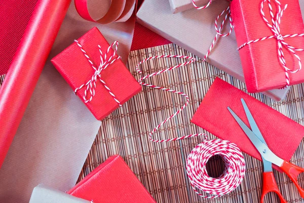 Preparing for the holiday - gift wrapping in red and beige wrapping paper