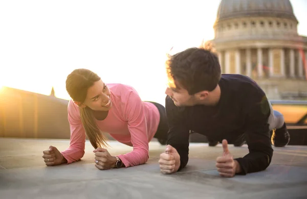 Friends doing sport together on a rooftop in London
