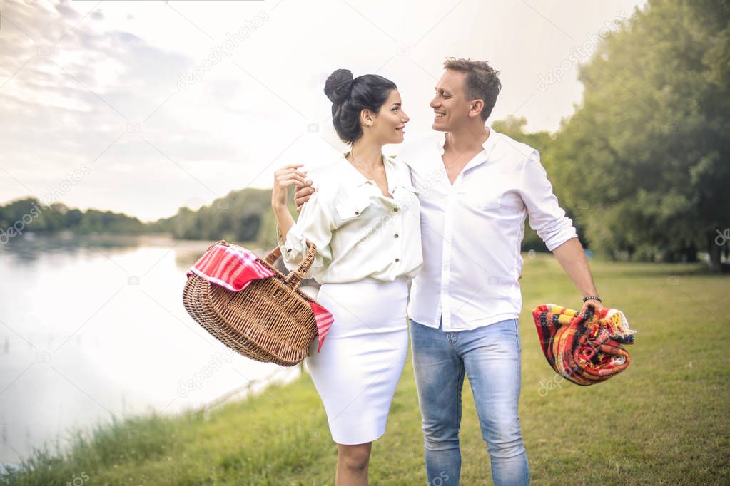 Happy young couple on a picnic in park