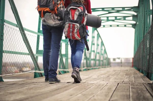 romantic couple of travelers walking on across the bridge
