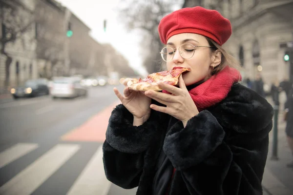 young beautiful woman eating pizza