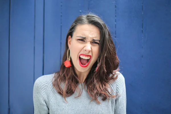 beautiful young woman screaming at camera