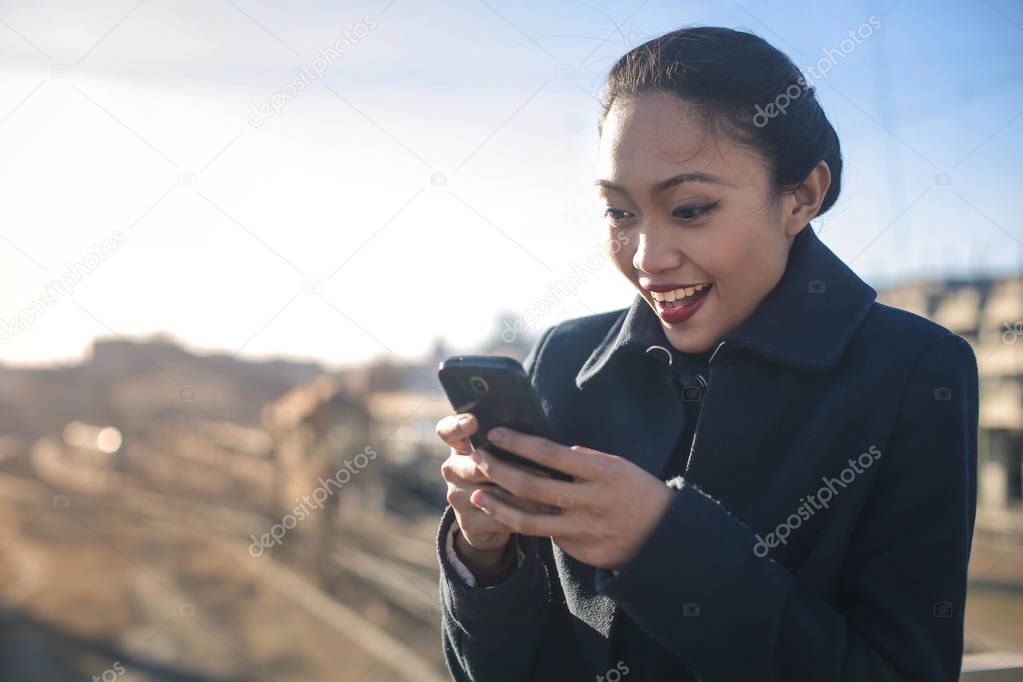 young brunette woman texting on her smartphone 