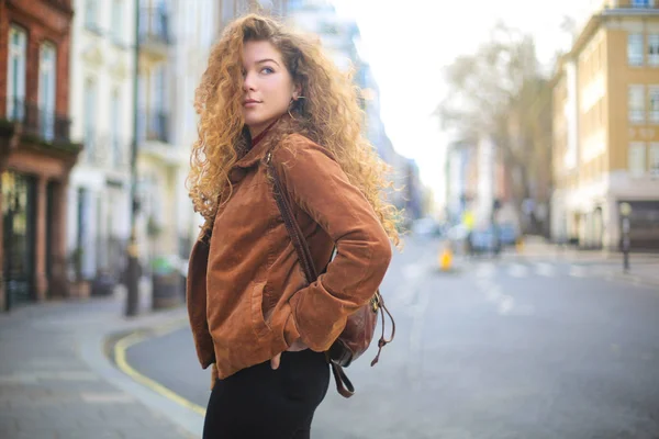 Beautiful curly hair woman walking in the street