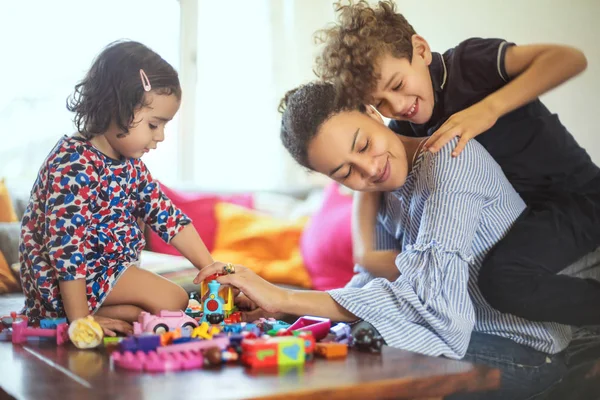 Sweet family playing with toys in the living room