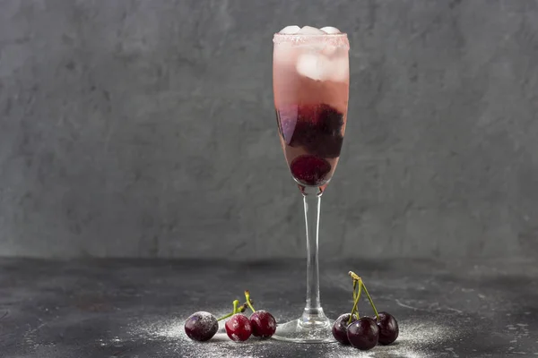 Cooling cherry cocktail with ice and a cherry