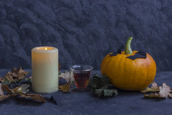 Fall Halloween pumpkins, candle, glass in the form of a skull on — Stock Photo, Image