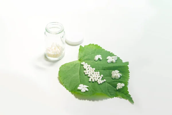 Homeopathic Globules Glass Bottle Green Plant Leaf White Background Konsep — Stok Foto