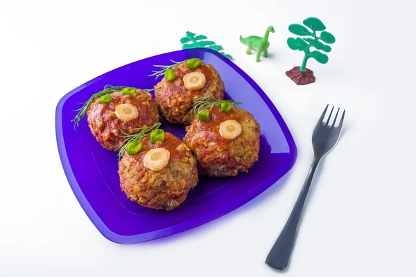 Child food. Funny food. Plate with buckwheat cutlets or meatballs in the form of funny faces decorated with greens. Children\'s or kids menu. Healthy eating. opy space for text
