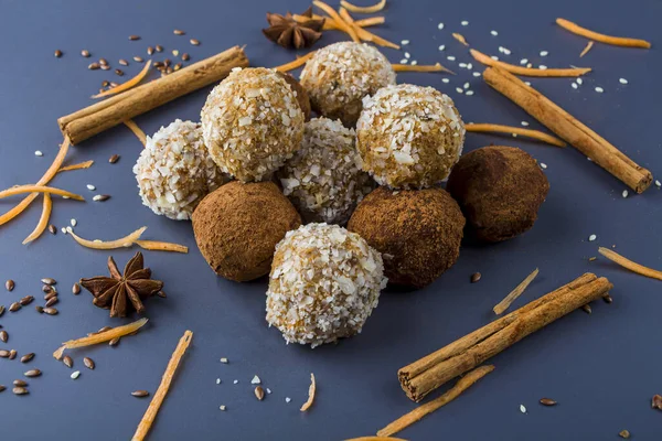 Homemade energy protein balls with  carrot, nuts, coconut flakes. Raw food desserts. Healthy vegetarian snack,  candies for Christmas decorated with anise star and cinnamon