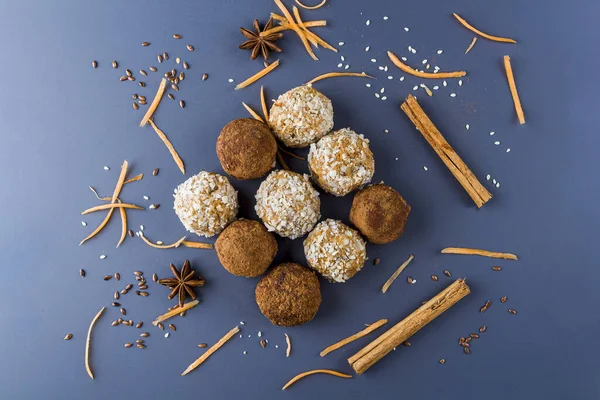 Homemade energy protein balls with  carrot, nuts, coconut flakes. Raw food desserts. Healthy vegetarian snack,  candies for Christmas decorated with anise and cinnamon